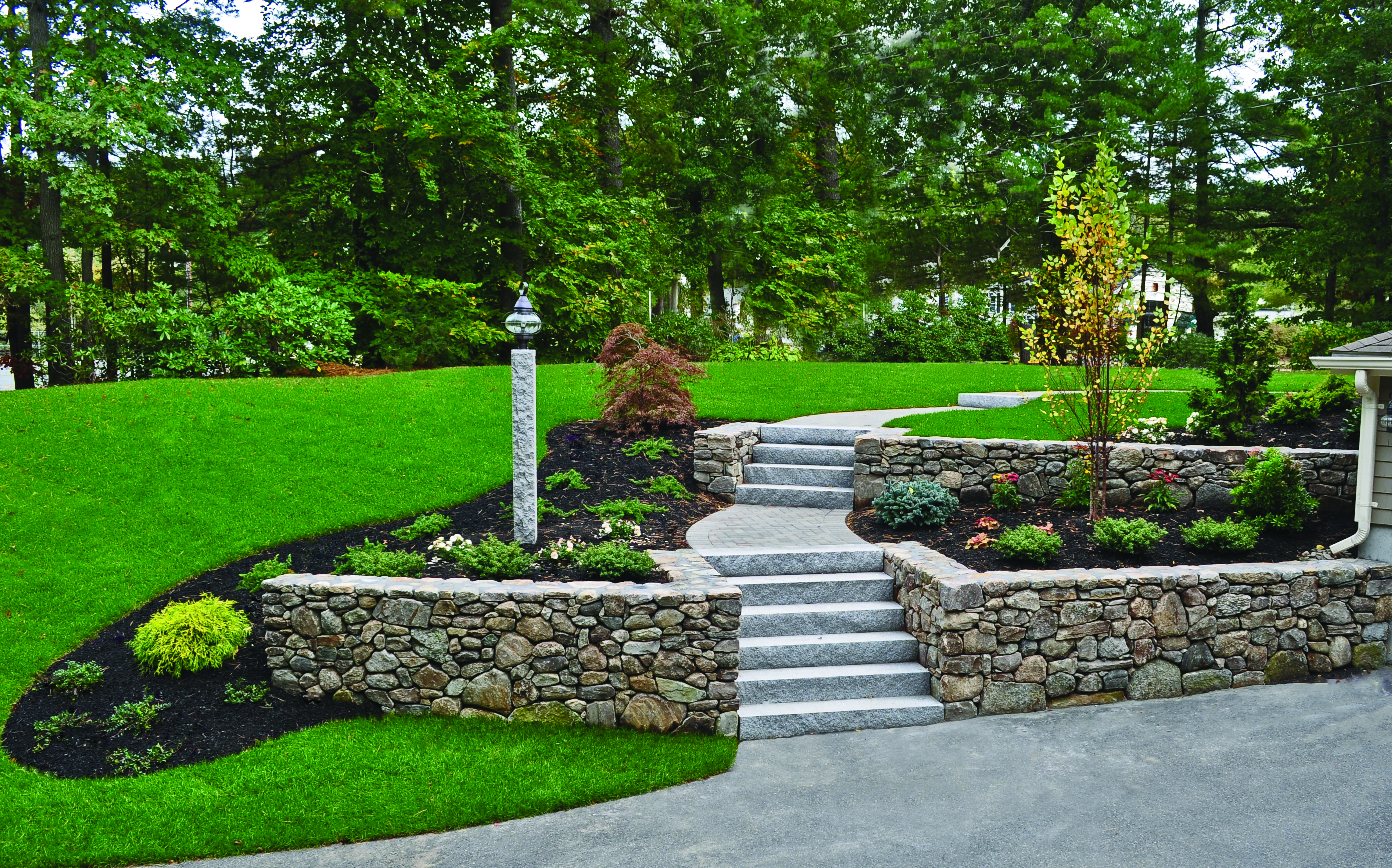 New England-style wallstone and Woodbury Gray granite steps